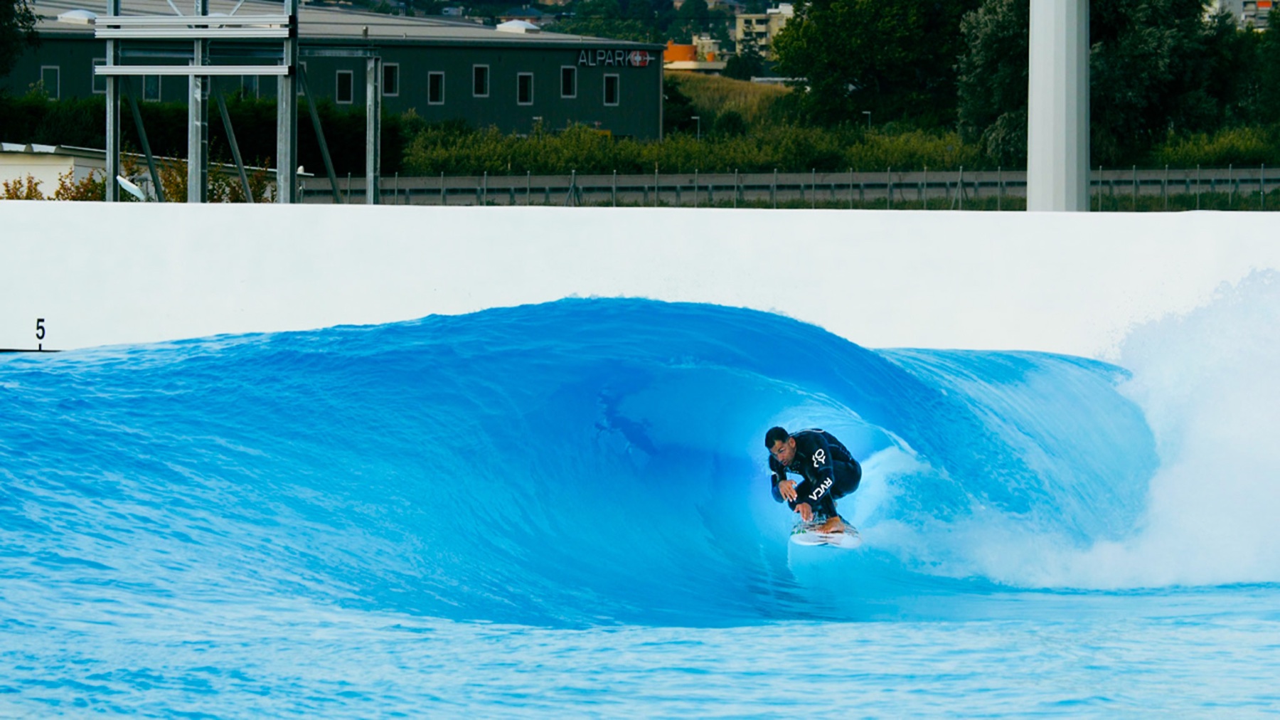 Surfer training in a wave pool barrel